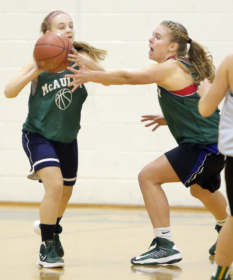 Mikayla Moran tries to get the ball past the outstretched arms of teammate Ayla Tarte during a defensive drill.