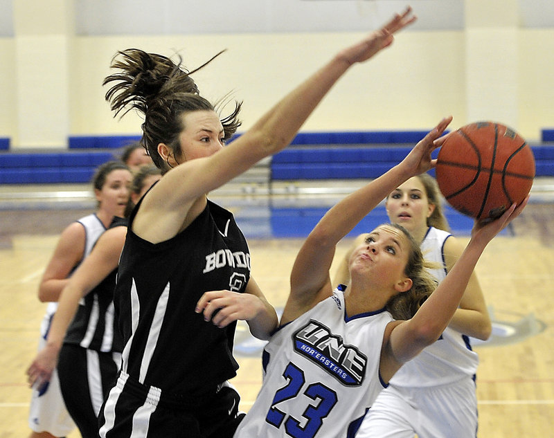 Alanna Vose, a University of New England freshman from Medomak Valley High, attempts to get her shot over Shannon Brady of Bowdoin during UNE’s 72-32 victory Tuesday night. UNE had lost 17 straight to the Polar Bears.