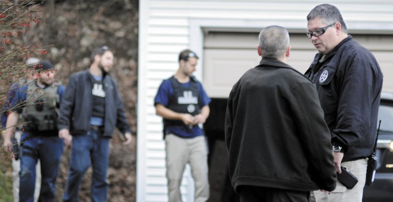 U.S. Marshals Service investigators search the residence of Barbara Cameron, the ex-wife of fugitive James Cameron, Tuesday afternoon in Hallowell. Authorities on Tuesday continued to hunt for Cameron, Maine’s former top drug prosecutor, who cut off his electronic monitoring bracelet and fled on Thuesday, after learning his appeal of child pornography convictions had partially failed.