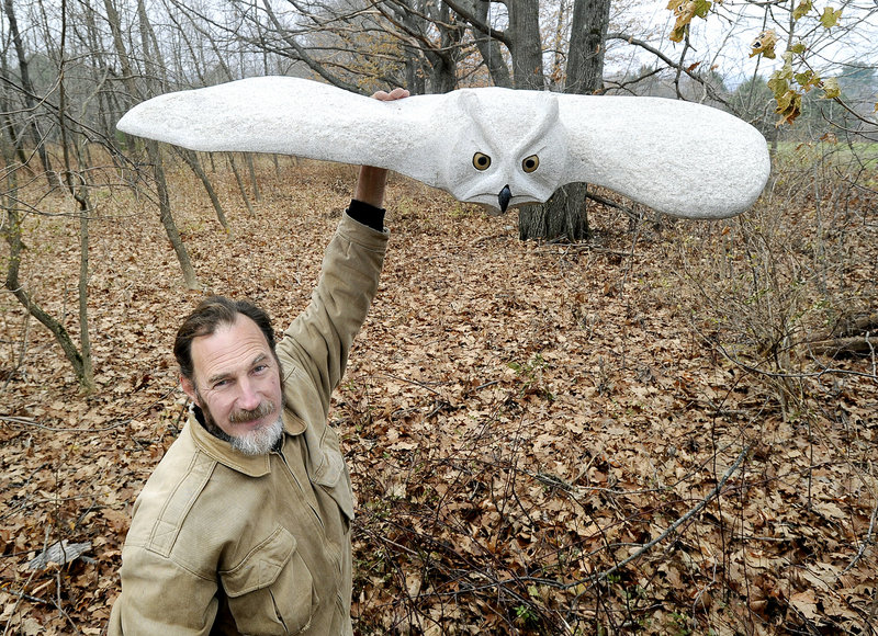Andreas von Huene, a Woolwich artist, displays his “Turning Owl” that’s among the new stone sculptures that have been added to a half-mile art trail over rolling hills and through orchards at the Viles Arboretum in Augusta.