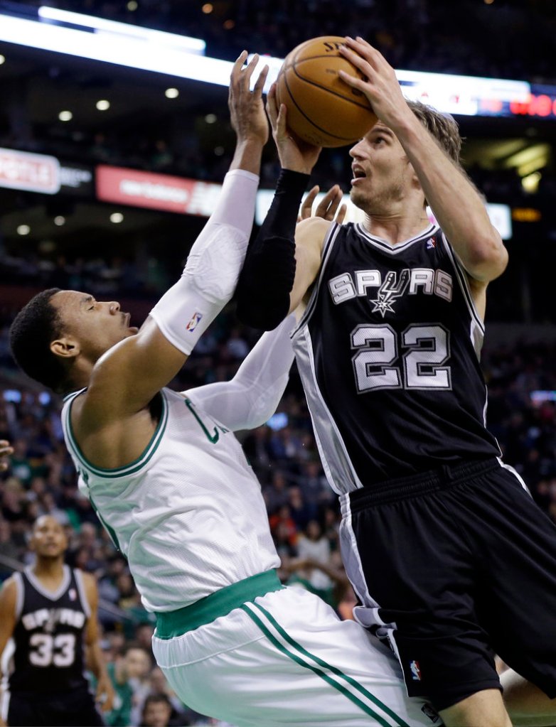 Tiago Splitter, who scored 23 points Wednesday night for San Antonio, drives against Jared Sullinger of the Boston Celtics during the first half of the Spurs’ 112-100 victory. Boston has lost three of its last four games.