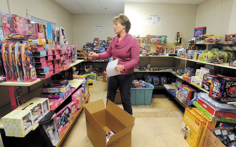 Cristen Sawyer, the Christmas program director at the Maine Children’s Home for Little Wanderers in Waterville, prepares Christmas gift boxes for needy children in central Maine.