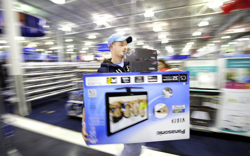 Cory Albert of Lebanon, Conn., races to the Best Buy checkout with a 32-inch television and a couple of headsets just after the store opened on Black Friday. In addition to the mall's anchor stores, 58 venues in the mall area opened their doors at midnight.