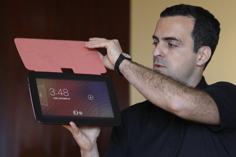 Hugo Barra of Google holds up the new Nexus 10 tablet, which beats the iPad’s screen resolution.