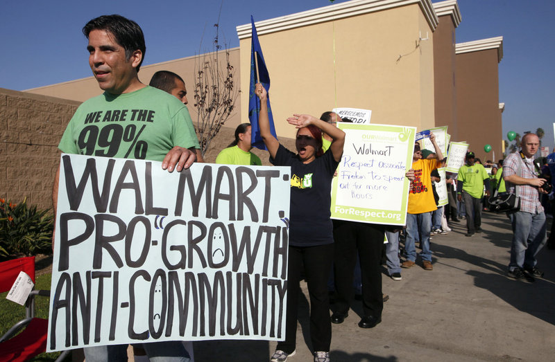 Anthony Degoege protests outside a Walmart store in Paramount, Calif., on Friday, as Walmart employees and union supporters took part in nationwide demonstrations for better pay and benefits.