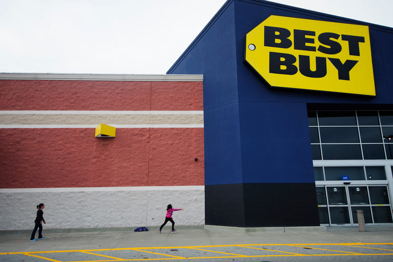 Children take a break Thursday from waiting in line at Best Buy in Carbondale, Ill. Richard Schulze, a former executive, is expected to offer as much as $8 billion to buy the company. His message is simple: His team created Best Buy – and only they can save it.