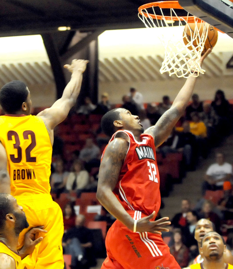 Kris Joseph, who finished with 28 points and eight rebounds for the Maine Red Claws, drives past D’Aundray Brown of the Canton Charge. Joseph helped the Red Claws open the season with a 123-115 victory on the road.