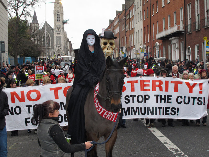 A masked rider depicting Death leads an austerity protest march in Dublin, Ireland, on Saturday. The government says it will unveil Ireland’s sixth-straight austerity budget next month in hopes of reducing the country’s 2013 deficit.