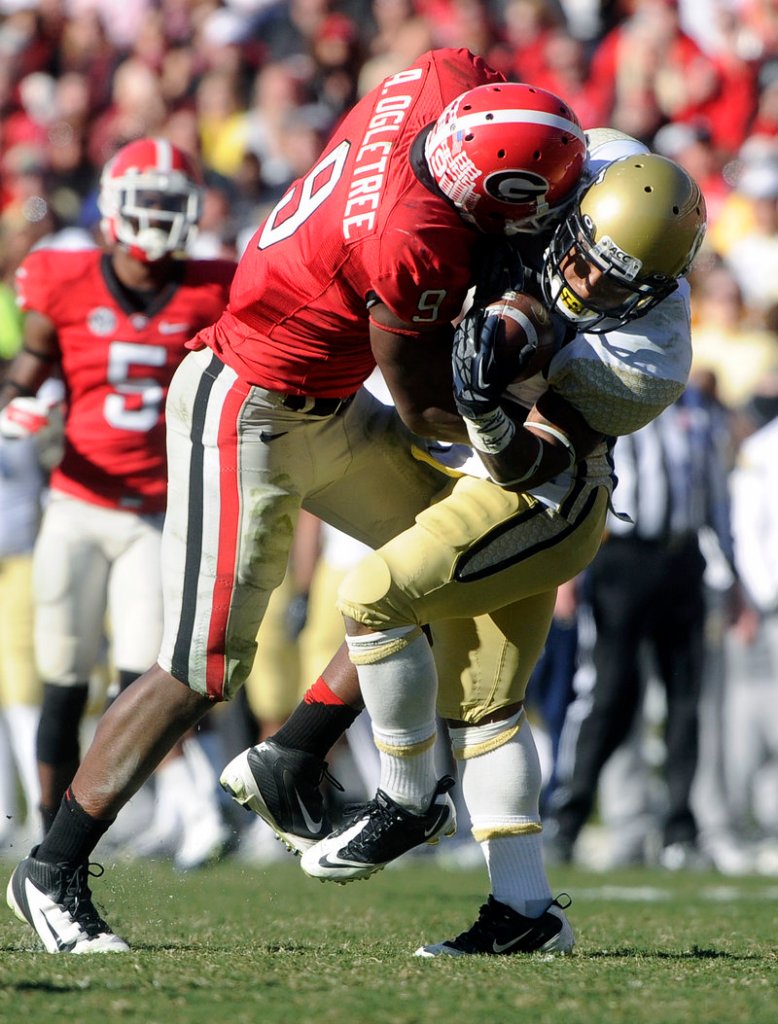 Georgia linebacker Alec Ogletree puts a hard hit on Georgia Tech’s Synjyn Days, and the Bulldogs went on the beat the Yellow Jackets 42-10 in Athens, Ga. on Saturday.