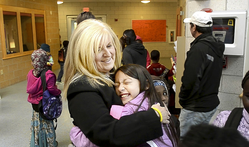 Marcia Gendron, principal of East End Community School in Portland, gets a hug from third-grader Maureen Fitzgerald at the start of a school day. Most of the 410 students come from racially diverse and poor neighborhoods.
