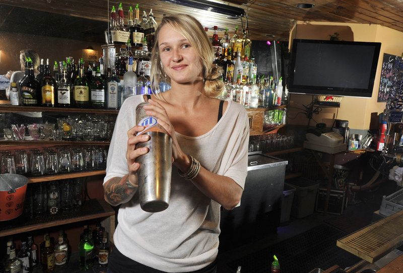 Erin Compton, bartender at The Big Easy in Portland, makes up a SoCo Hurricane, one of the bar’s more popular drinks.
