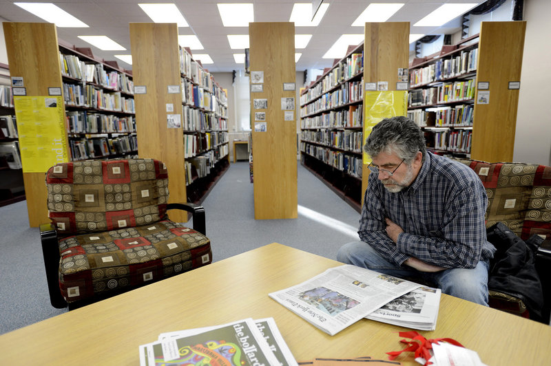 Jim Casey of Cape Elizabeth reads a newspaper at Thomas Memorial Library on Monday, Nov. 26, 2012.