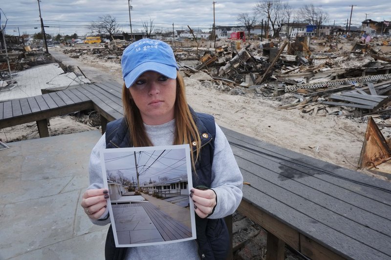 Meghan McGovern of the New York borough of Queens shows a photo of the scene behind her that she took Oct. 27, two days before superstorm Sandy arrived. A fire during the storm destroyed more than 100 homes in her neighborhood; hers survived. Residents of areas hit hard by Sandy would welcome the funds we now send abroad, a reader says.