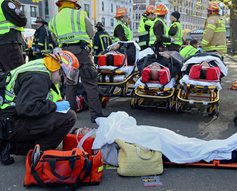 First responders tend to some of the injured after two trolleys collided in a subway station on Thursday, Nov. 29, 2012 in Boston. An MBTA spokesman says six people were taken the hospital and more than 20 others were evaluated. T spokesman Joe Pesaturo says there was no derailment and no visible damage to either two-car trolley after the slow-speed accident just before noon on Thursday in the Boylston Street station.