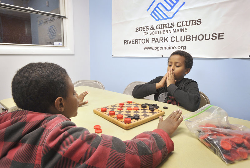 Abdibasil Hassan, left, and Abdihakim Ukash play a game of checkers at the Riverton Park Clubhouse on Thursday, Nov. 29, 2012. The Boys & Girls Club of Southern Maine, in partnership with the Portland Housing Authority, have just completed a $180,000 expansion to the club to allow for more children.