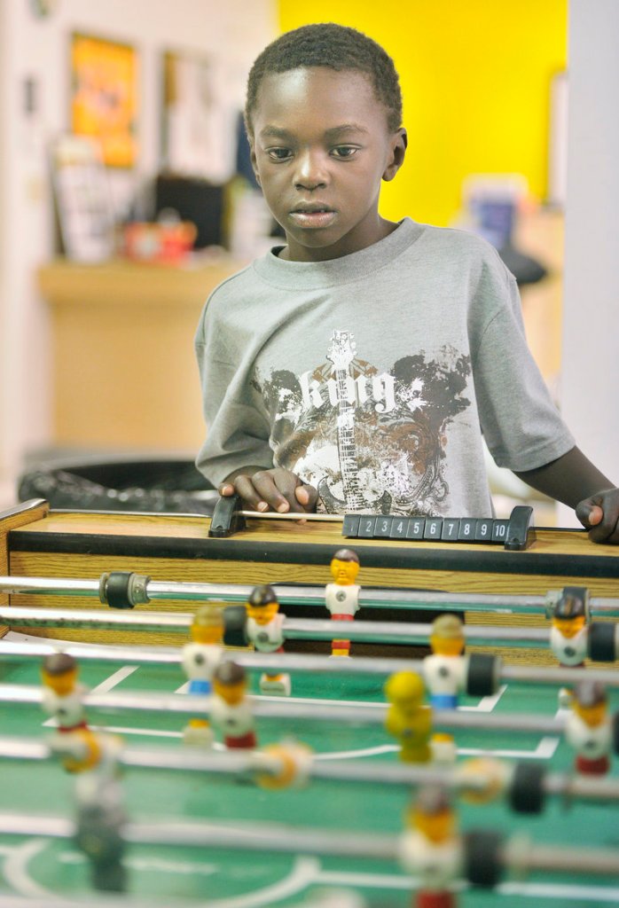 Jamal Ali closely watches a game of FoosBall on Thursday afternoon at the Clubhouse.