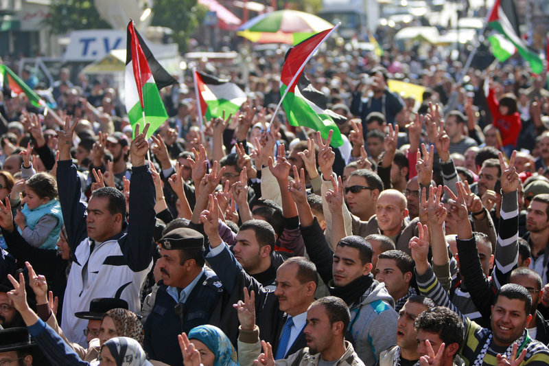 People wave Palestinian flags during a rally supporting the Palestinian U.N. bid for nonmember observer state status in the West Bank city of Ramallah on Thursday.