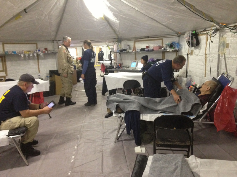 A staffer attends to an evacuee from a nearby nursing home in the fully equipped acute care tent that’s part of the temporary medical facility erected at Lehman College in the Bronx after Hurricane Sandy.