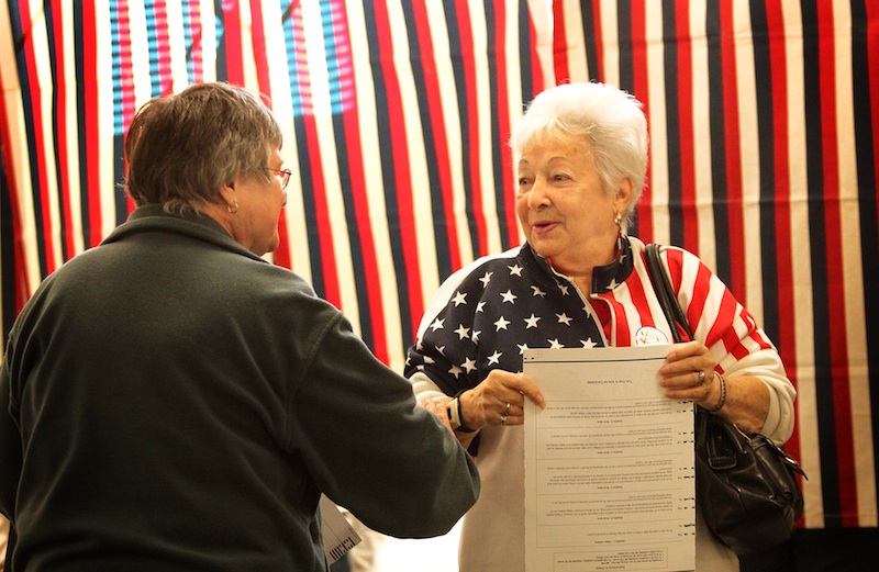 Alice Voisine, right, greets her friend Rita Probost while voting in Skowhegan on Tuesday.