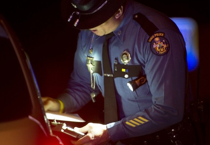 Maine State Police Trooper Doug Cropper talks with a motor vehicle operator after pulling him over for speeding on I-295, in this December 2011 photo.
