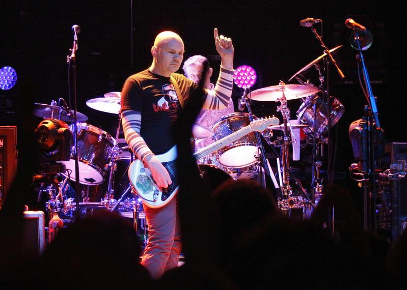 Smashing Pumpkins lead singer Billy Corgan signals to the crowd during the band's opening set Saturday at the State Theatre.
