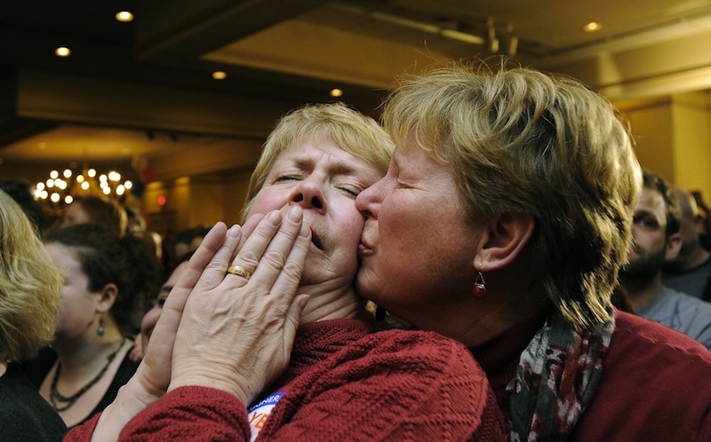 Ellie MacCallum, left, of Windham, receives a kiss from her partner, Judy Eycleshymer, right, after they learned same sex marriage had passed while at the Mainers United for Marriage party at the Holiday Inn by the Bay Tuesday, November 6, 2012. Marriage licenses for same-sex couples in Maine could be issued beginning Dec. 29.