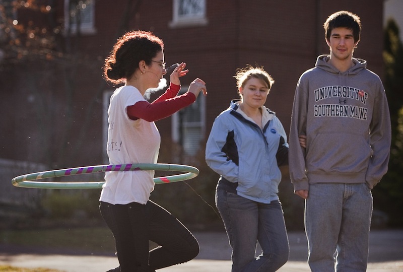 USM student, and protest organizer Jordana Avital, smokes while spinning a hula hoop during a protest of a proposed smoking ban on USM campuses at the Gorham campus on Monday. Fellow students Michaela Thibeault and Richar Cost look on, at right.