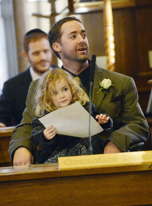 Re-elected City Councilor Kevin Donoghue sits at the dais in council chambers with his daughter Rosaleen 2, after being sworn in Monday.