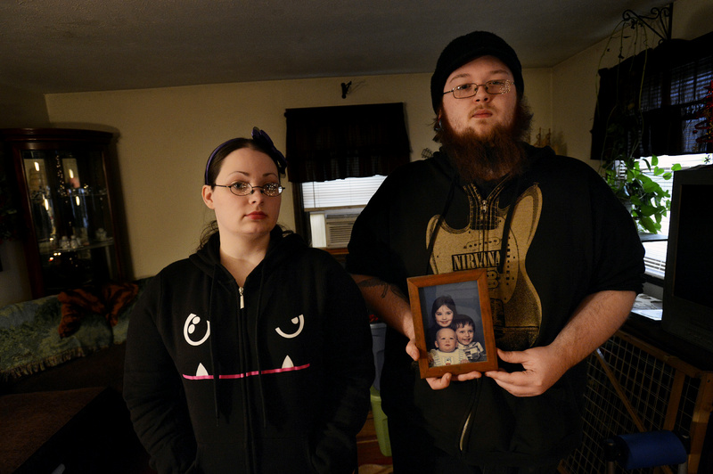 Andrew Landry was close to his cousins, Jennifer Smalley, 26, left, and her brother Travis Smalley, 21, of Sanford. Travis holds a portrait of the three of them when they were children. Jennifer says in the week preceding her cousin’s death in a confrontation with police, she witnessed what appears to have been the onset of a psychotic episode in him.