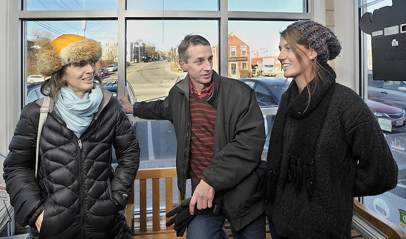 On Wednesday, Dec. 12, 2012, Mainers answer the question, "Do you think the world will end on December 21?" Cornelia Walworth, left, Mark McCain and his daughter, Chase McCain, respond in different ways in the foyer of Becky's Diner in Portland.