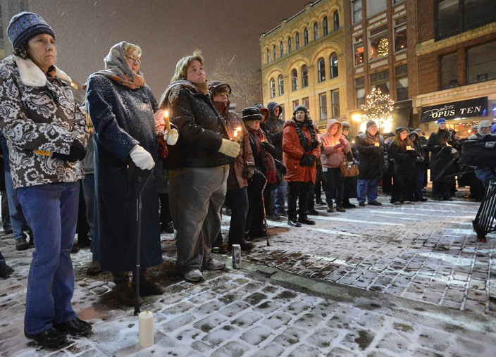 Participants in Sunday’s vigil in Portland called for stricter rules on gun sales. “People don’t need an assault rifle to hunt or to protect themselves,” said Mayor Michael Brennan.