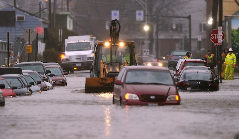 A bucketloader approaches a submerged van on Somerset Street in Portland Wednesday, December 19, 2012, after a water main break caused flooding through much of the area.