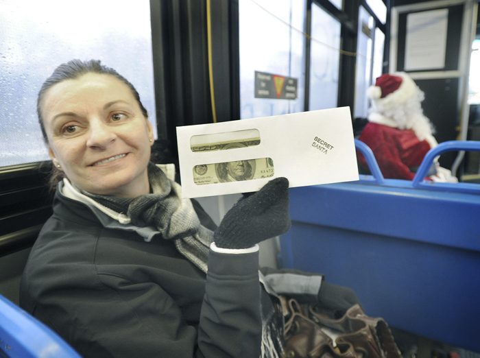 Aneta Rosa from Westbrook was one of many lucky Metro bus riders to receive a $100 bill from the Secret Santa who rode the bus from Westbrook to Portland and back to Westbrook on Friday.