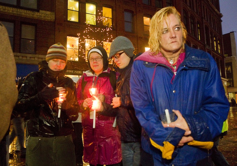 Sherri Ferrier, participates in the annual homeless vigil at Monument Square on Friday. Participants announced the names of 30 homeless people who died in the past year. Ferrier, who recently moved into a shelter, was there to remember her friend Deb, among others.