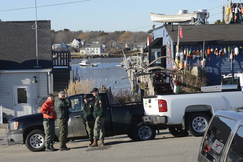 Staff Photo by Shawn Patrick Ouellette: Members of the Maine Marine Patrol and Maine Game Warden Services talk in Cape Porpoise Monday, December 24, 2012. Zachary Wells and Prescott Wright, have been missing from Kennebunkport since Wednesday.