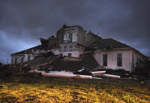 Lightning flashes as another line of thunderstorms approaches a severely damaged home near McNeill, Miss. on Tuesday, Dec. 25, 2012. A Christmas Day twister outbreak left damage across the Deep South while holiday travelers in the nation's much colder midsection battled sometimes treacherous driving conditions from freezing rain and blizzard conditions. (AP Photo/Hattiesburg American, Ryan Moore)