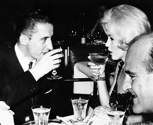 Marilyn Monroe and Jean Pierre Piquet, left, manager of Continental Hilton Hotel, lift their champagne glasses at a Feb. 26, 1962, reception offered to the visiting star, in Mexico City. The FBI has released a new version of files it kept on Monroe that reveal the names of some of her acquaintances who had drawn concern from government officials and members of her entourage over their suspected ties to communism.