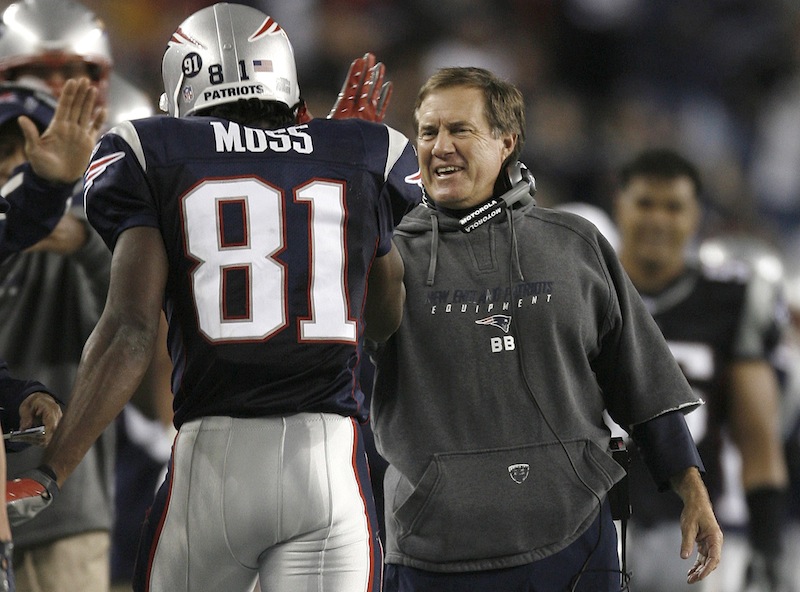 In this Sept. 16, 2007 file photo, New England Patriots head coach Bill Belichick, right, congratulates wide receiver Randy Moss (81) after his second touchdown catch in the third quarter of an NFL football game against the San Diego Chargers in Foxborough, Mass. Moss arrived at the Patriots five years ago thinking he knew a lot about football. Then, he began playing for Belichick. Moss' mindset regarding his own football knowledge changed in a hurry. Only then did he learn the intricacies of his sport from "A to Z," as the 49ers wide receiver now puts it. (AP Photo/Winslow Townson, File) NFL