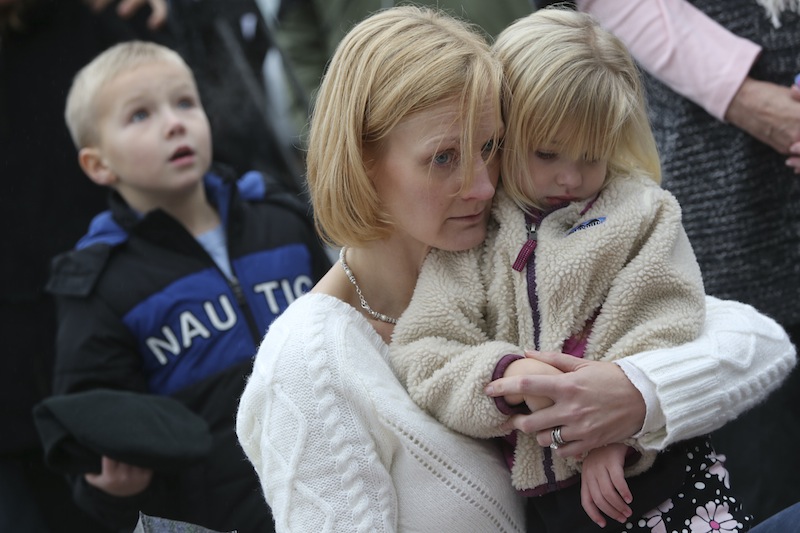 Barbara Wells of Shelton, Conn., holds her daughter Olivia, 3, as she pays her respects Monday, Dec. 17, 2012 at one of the makeshift memorials for the victims of the Sandy Hook Elementary School shooting in Newtown, Conn. (AP Photo/Mary Altaffer)