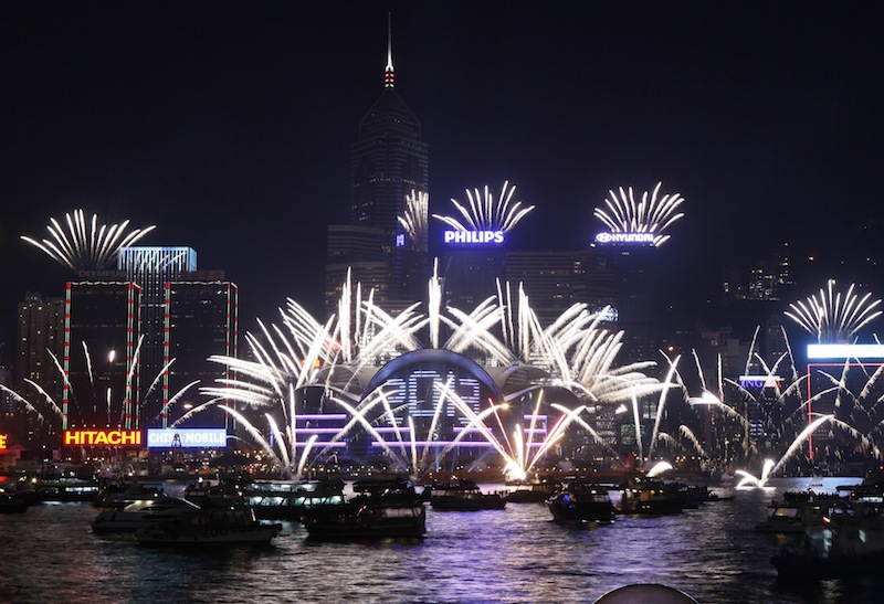 Fireworks explode at the Hong Kong Convention and Exhibition Centre over the Victoria Harbor to celebrate the 2013 New Year in Hong Kong Tuesday, Jan. 1, 2013 (AP Photo/Kin Cheung)