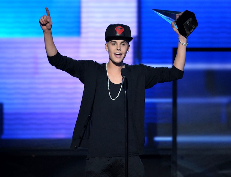 In this Nov. 18, 2012 file photo, Justin Bieber accepts the award for favorite album - pop/rock for "Believe" at the 40th Anniversary American Music Awards, in Los Angeles. New documents show an obsessed prisoner hatched a plot to castrate and kill the pop star. (Photo by John Shearer/Invision/AP, File)