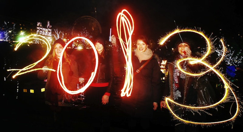 Katy Saunders, left, Alex Mueller, center left, Rebekka Frank and Arina Motamedi, right, play with sparklers ahead of welcoming in the new year during the 2013 Edinburgh Hogmanay celebrations, Scotland, Monday December 31, 2012. See PA story SOCIAL NewYear. (AP Photo/PA,Danny Lawson)
