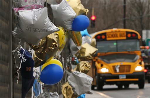 Classes resumed Tuesday for Newtown schools except those at Sandy Hook. Buses ferrying students to schools were festooned with large green and white ribbons on the front grills, the colors of Sandy Hook. At Newtown High School, students in sweatshirts and jackets, many wearing headphones, betrayed mixed emotions.