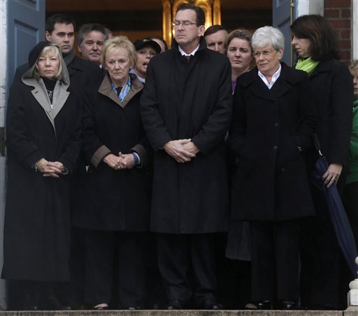 Connecticut Gov. Dan Malloy, center, stands with other officials to observe a moment of silence while bells ring 26 times in Newtown, Conn., in honor of the Sandy Hook Elementary School victims.