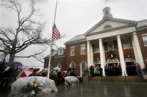 Officials including Connecticut Gov. Dan Malloy observe a moment of silence on the steps of Edmond Town Hall while bells ring 26 times in Newtown, Conn., on Friday.
