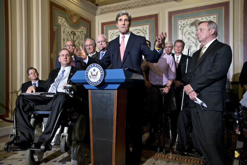 Senate Foreign Relations Committee Chairman Sen. John Kerry, D-Mass., center, gestures during a news conference on Capitol Hill in Washington, Monday, Dec. 3, 2012, to urge Senate approval of an international agreement for protecting the rights of individuals with disabilities. From second from left are, Rep. Jim Langevin, D-R.I., Sen. Tom Harkin, D-Iowa, Sen. John McCain, R-Ariz., Kerry and Senate Majority Whip Richard Durbin of Ill. (AP Photo/J. Scott Applewhite)