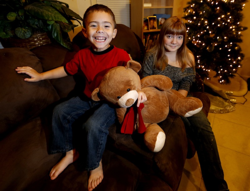 McKenna Pope, 13, right, and her brother Gavyn Boscio, 4, pose for a photo at their home in Garfield, N.J. on Thursday, Dec. 6, 2012. Pope started a petition demanding the toy company Hasbro make its Easy-Bake Oven more boy friendly. She was inspired to do so when Gavyn put the oven on his Christmas wish list and she and their mother, Erica Boscio, found the toy only available with girls on the packaging and in pink or purple colors. The petition garnered more than 30,000 signatures in a little more than a week. (AP Photo/Julio Cortez)
