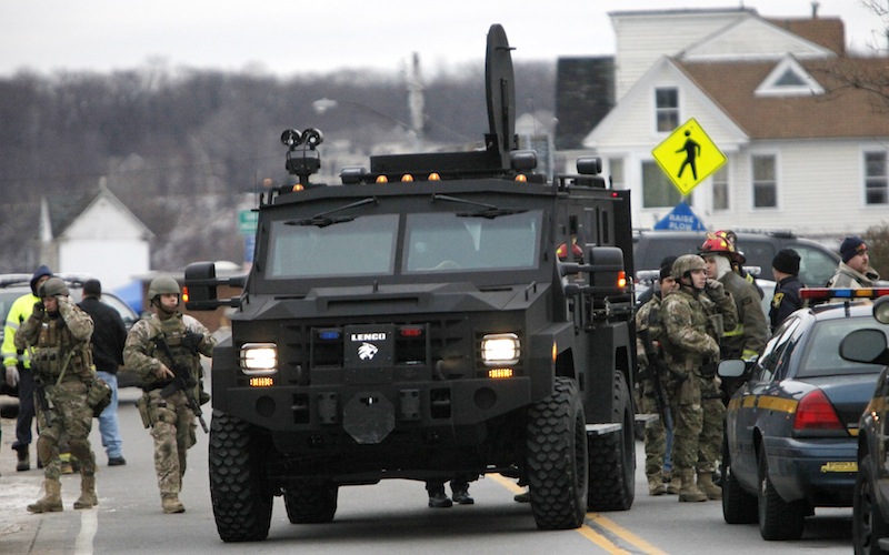A Monroe County Sheriff's Department armored truck drops off residents who were evacuated from the neighborhood where two Webster firefighters were killed and two others were wounded by a gunman on Monday morning. Seven houses were destroyed. The gunman died of a self-inflicted gunshot wound.