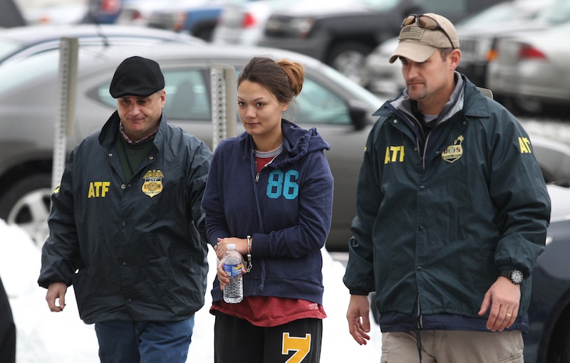 Dawn Nguyen is escorted into the Federal Building, Friday, Dec. 28, 2012, in Rochester, N.Y., and charged in connection with the guns used in the Christmas Eve ambush slaying of two volunteer firefighters responding to a house fire in Webster, N.Y. (AP Photo/Democrat & Chronicle, Jamie Germano)