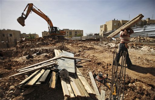 A Palestinian man works at a construction site in East Jerusalem in a 2010 file photo. On Monday, Israel said it was moving ahead with plans to build hundreds of homes in a Jewish settlement of East Jerusalem.